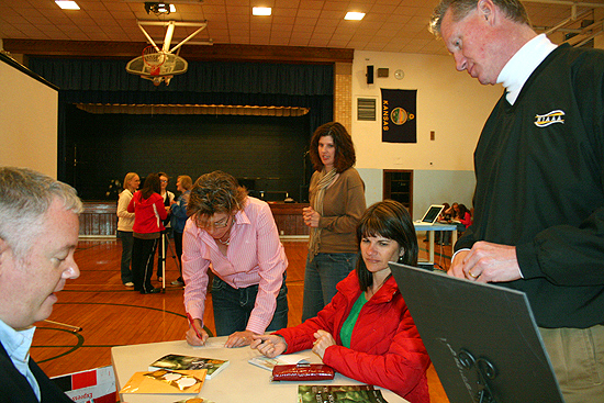 Signing books for students, teachers, and the principal of Norton Junior High School - Norton, Kansas.