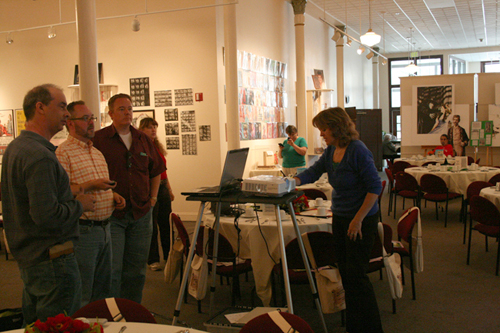 Setting up at the Columbian Theatre in Wamego, Kansas. Left to right: Paul Bienvenue, Grant Hayter-Menzies, Paul Miles Schneider, and Catherine Bienvenue observe, while Jane Albright adjusts the projector.