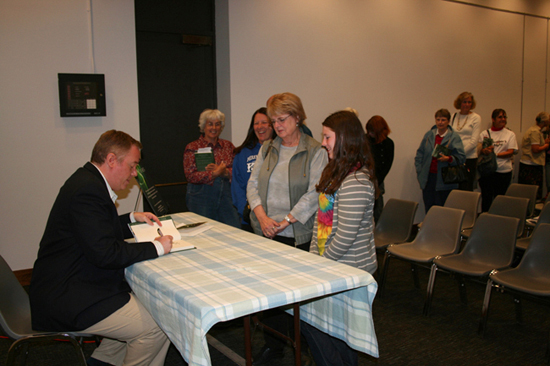 Paul Miles Schneider signs copies of his novel “Silver Shoes” after his presentation at the Lawrence Public Library. October 6, 2009.