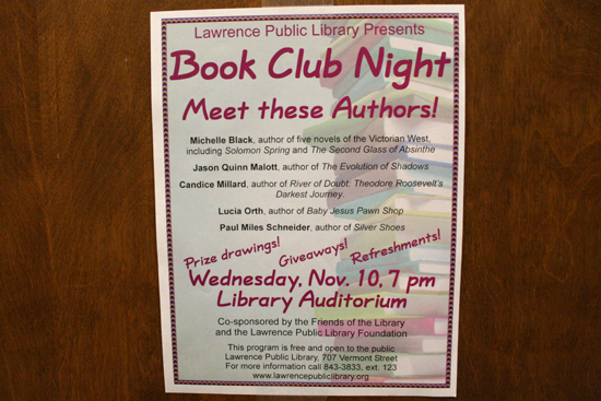 A Book Club Night flyer posted on a hallway wall.