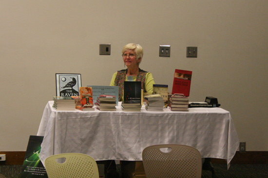 Julie Trowbridge-Alford of the Raven Bookstore sells the authors' books, including "Silver Shoes," at Book Club Night.