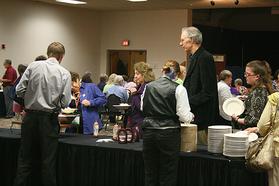 The ice cream bar at the Kansas Library Association's Happy Hour with Kansas Authors. 2011. Guest author Roderick Townley towers above the rest while waiting in line.