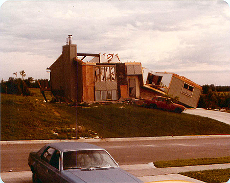 The house across the street from Mike’s, taken from his porch. At the time of this photo, the small red car had already been rolled right-side up. (Photo courtesy of Michael T. Sheridan.)