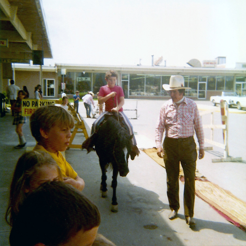 Paul Miles Schneider riding Admiral, while the pony’s owner, Hollywood stunt performer Dick Ryan, leads them around a simple course in the parking lot.